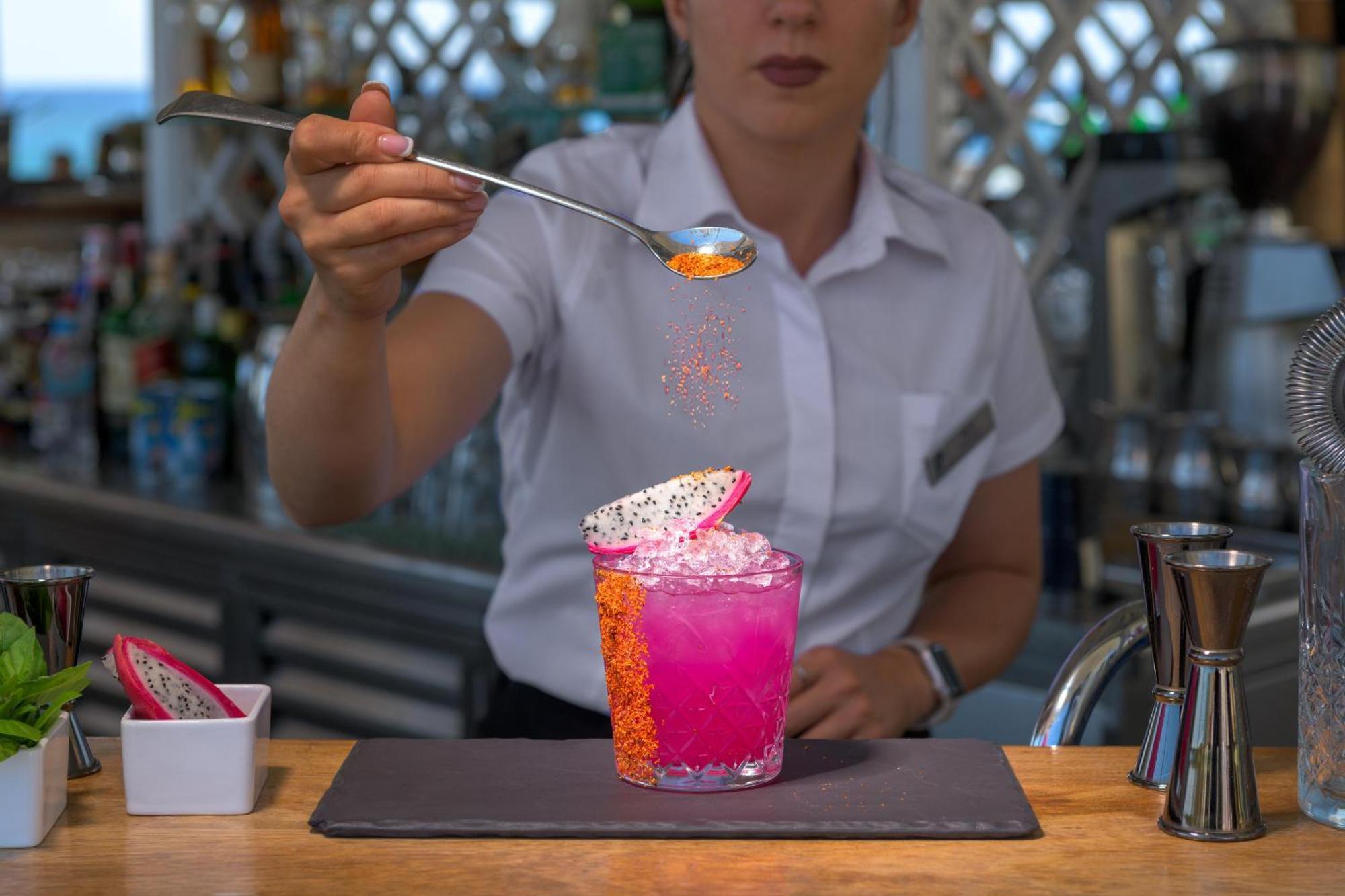 Rodos Palladium Leisure & Wellness Kallithea  Екстер'єр фото A bartender adding a garnish to a cocktail